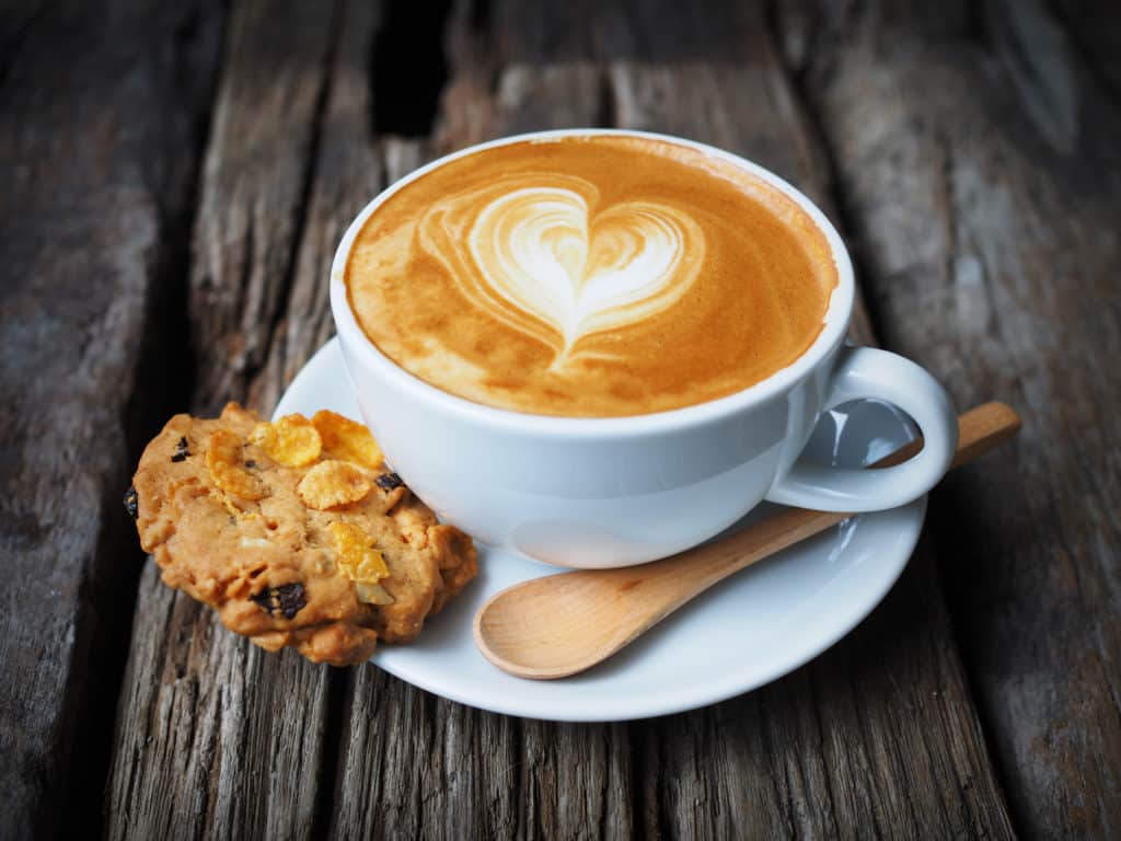 cup of coffee and cookie in coffee shop vintage color